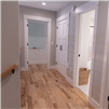 Hand Scraped Hickory Natural Hurst Hardwoods Prefinished Solid Flooring installed in a modern hallway